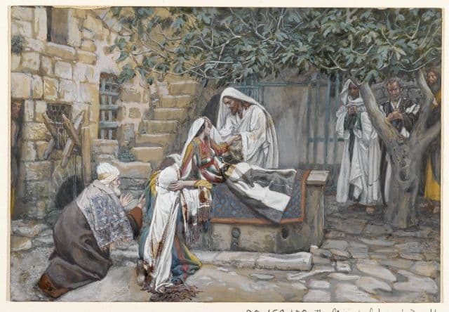 Jesus stands near a young girl in an interior room, reaching toward or holding her as others look on. The atmosphere is hushed, emphasizing the moment when death gives way to life.
