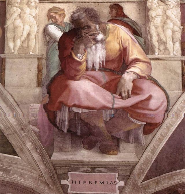 Jeremiah appears as a monumental seated figure, head bent and one hand near his face. His body looks heavy and inward, as if the prophetic word weighs on him. The muted fresco tones and strong posture make the image feel contemplative rather than triumphant.