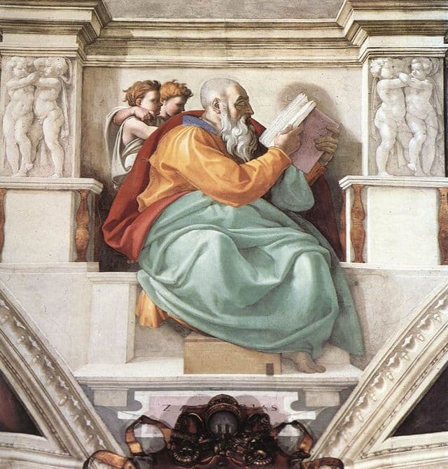 Zechariah sits as a large, sculptural figure reading from a book, with small attendants behind him. His posture suggests concentrated attention, study, and the gravity of prophetic hope.